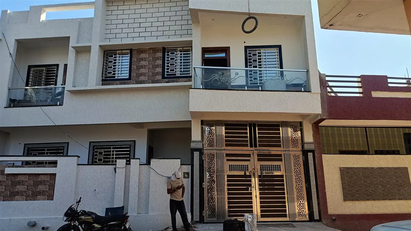 Completed facade with glass railing and designer gate