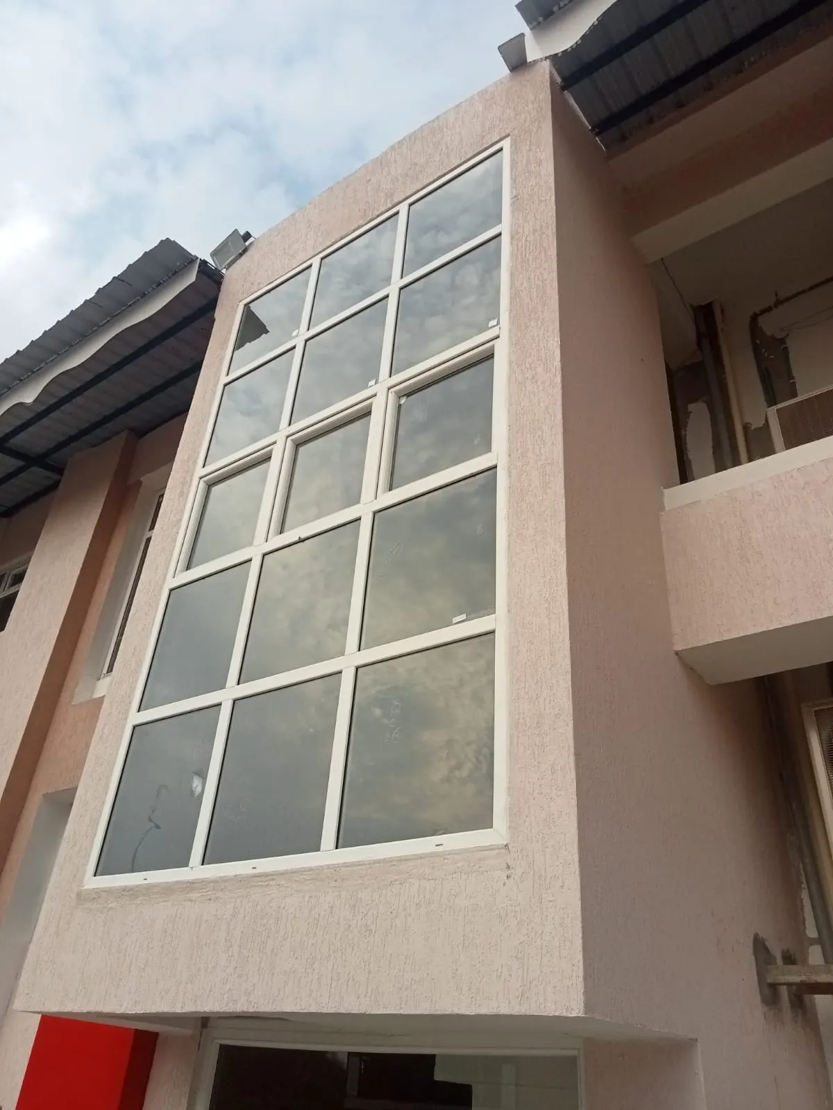 White uPVC glazed windows on a building facade in Lalitpur